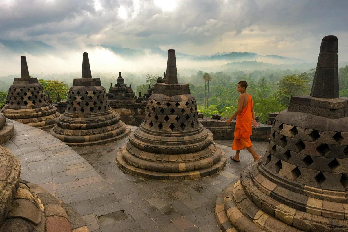 Visitors at Borobudur Temple in traditional modest clothing, Central Java